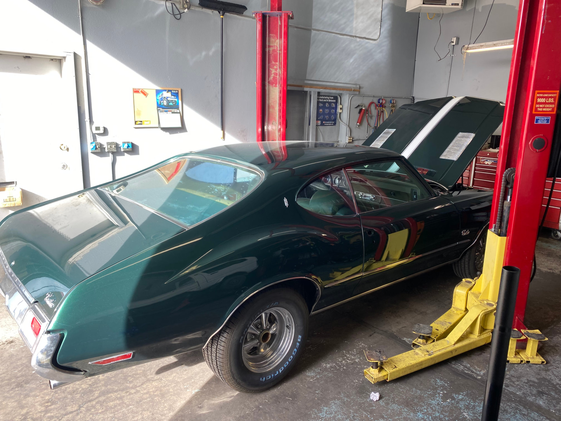 Classic Oldsmobile Cutlass on the lift for repair work at Steiner Auto & Diesel