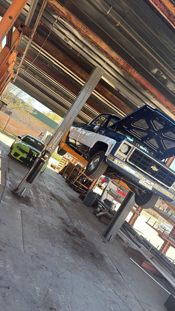 Classic Chevrolet pickup raised on the two-post lift inside the Steiner Auto & Diesel shop in Prescott, Arizona